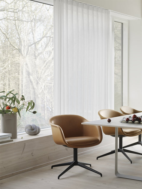 scandinavian dining room with leather dining chair and white dining table by muuto 