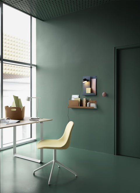 Close-up of Muuto folded shelving system in neutral-toned bedroom for space-saving storage