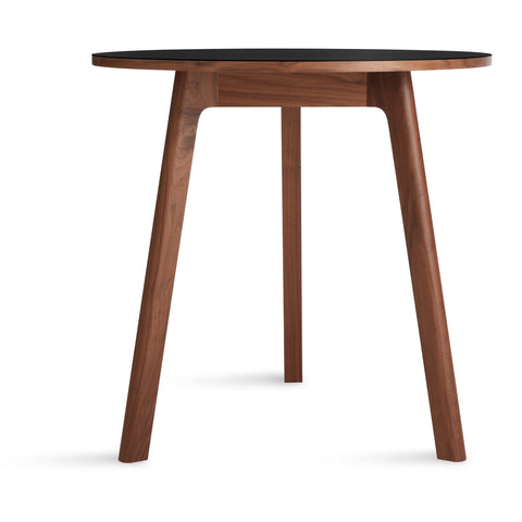 Blu Dot Apt 30-inch Round Cafe Table with black linoleum top and walnut base on white background