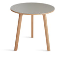 Blu Dot Apt 30-inch Round Cafe Table with putty linoleum top and white oak base on white background