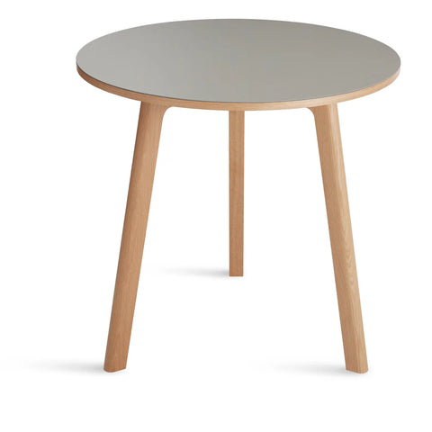 Blu Dot Apt 30-inch Round Cafe Table with putty linoleum top and white oak base on white background