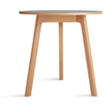 Blu Dot Apt 30-inch Round Cafe Table with putty linoleum top and white oak base on white background
