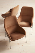 Three Blu Dot Acre Lounge Chairs in camel velvet with brushed steel legs, arranged in a cluster on light hardwood flooring, shot from above