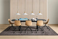 Blu Dot Good Times oval dining table in black oak styled with light wood swivel chairs and white pendant lights