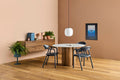 Blu Dot 4/4 Round Dining Table with marble top and white oak base styled in a warm dining room setting