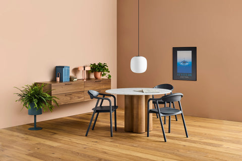 Blu Dot 4/4 Round Dining Table with marble top and white oak base styled in a warm dining room setting