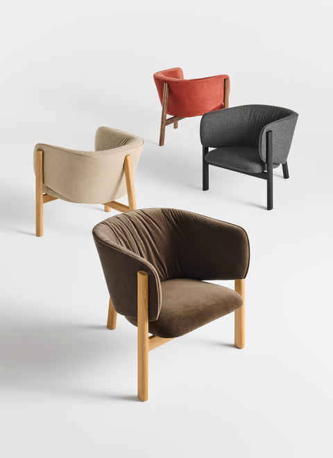 Blu Dot All In Lounge Chair in four upholstery options — brown velvet, cream boucle, terracotta velvet, and charcoal — with natural oak and black wood frames
