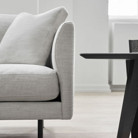detail image of scandinavian sofa in grey fabric and black metal legs 