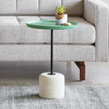 Gus* Modern Agency Table, round side table, Robusta green top on a travertine base in front of a grey tufted sofa