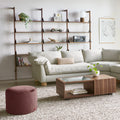 Gus* Modern Branch-3 Shelving Unit, walnut wall shelving above a cream sectional sofa and walnut coffee table