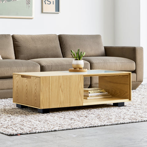 Gus* Modern Conway Coffee Table, oak storage coffee table, Royal Oak in front of a taupe sofa on a textured rug