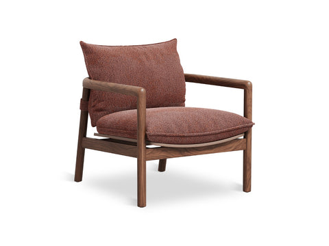 Gus* Modern Humber Lounge Chair, walnut frame lounge chair, Regency Beet upholstery in a three-quarter view on white