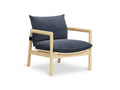 Gus* Modern Humber Lounge Chair, ash frame lounge chair, Regency Nautica navy upholstery in a three-quarter view on white
