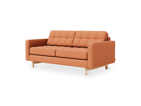 Gus* Modern Jane 2 Loft Sofa, tufted apartment sofa, Caledon Sedona terracotta with natural ash base, three-quarter view on white