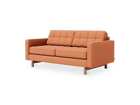 Gus* Modern Jane 2 Loft Sofa, tufted apartment sofa, Caledon Sedona terracotta with walnut base, three-quarter view on white