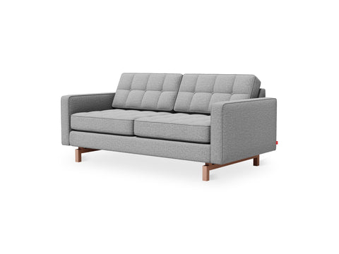 Gus* Modern Jane 2 Loft Sofa, tufted apartment sofa, Parliament Stone grey with walnut base, three-quarter view on white
