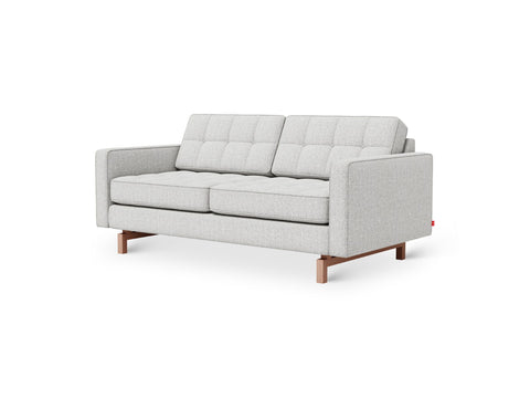 Gus* Modern Jane 2 Loft Sofa, tufted apartment sofa, Robarts Sauble light grey with walnut base, three-quarter view on white