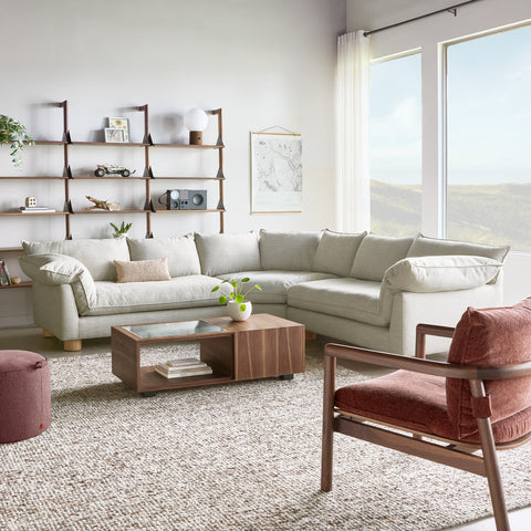 Gus* Modern Zoe Bi-Sectional, corner sectional sofa, Sutton Canvas cream in a living room with a wood coffee table and leather chair