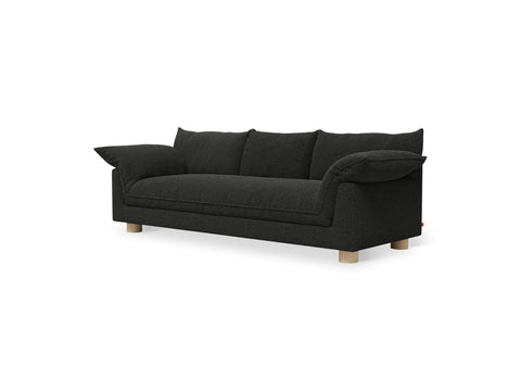 Gus* Modern Zoe Sofa, upholstered three seat sofa, Node Nocturne charcoal fabric with oak legs, three-quarter view on white