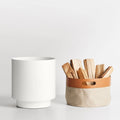 Carry Firewood Carrier by Blu Dot in white powder-coated aluminum, shown with removable canvas tote and leather handle cutout