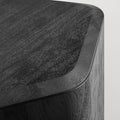 Close-up of the black-stained acacia wood grain and beveled top edge on the Blu Dot Hoard Tall Side Table
