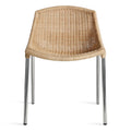 modern natural rattan dining chair with stainless steel legs by blu dot