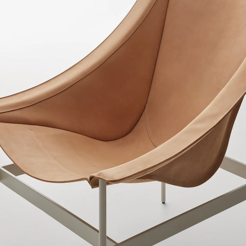 Detail view of the Blu Dot Heyday Lounge Chair in sand leather with a light grey steel frame showing the sling construction