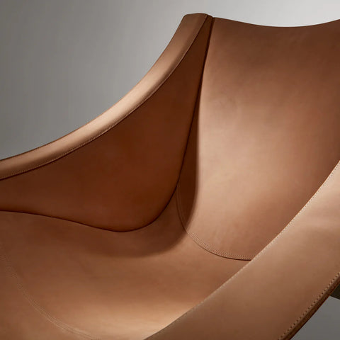 Close-up of the Blu Dot Heyday Lounge Chair in sand leather showing the natural grain and stitched seams
