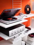 String System media shelf in white used for vinyl turntable and Copland amplifier, styled with records and books