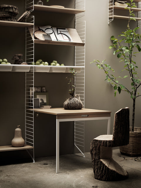 String Furniture modular shelving with bowl shelf, folding work desk, and Scandinavian design elements