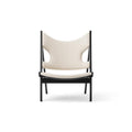 Front view of the upholstered Knitting Lounge Chair by Audo Copenhagen with sculptural cut-out backrest.