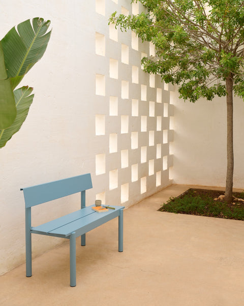 Muuto Linear Steel Bench with Backrest 110 cm in pale blue on minimalist courtyard patio