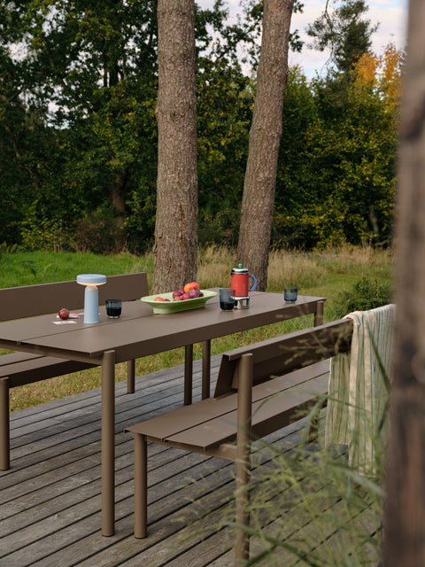 Muuto Linear Steel Bench with Backrest in taupe with Linear Steel Table 200 on outdoor wood deck