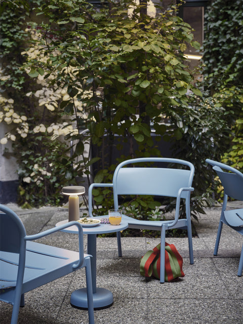 outdoor scandinavian lounge chair in blue lifestyle image by muuto 