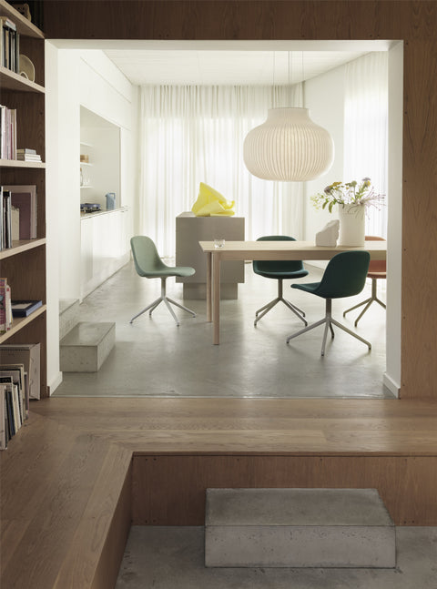 wood panel wall dining room interior with furniture and lighting by muuto