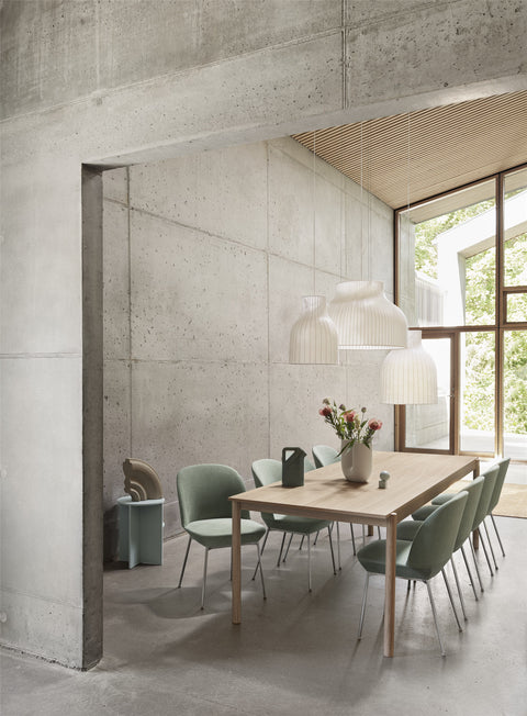 scandinavian modern interior with concrete walls and oak dining table