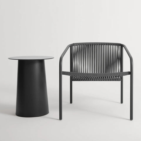 Lookout Outdoor Lounge Chair by Blu Dot in carbon, styled with outdoor side table
