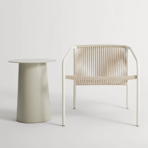 Lookout Outdoor Lounge Chair by Blu Dot in white, styled with outdoor side table