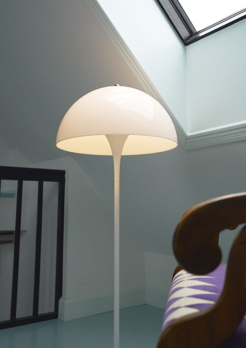 Louis Poulsen Panthella 400 Floor Lamp, white opal acrylic floor lamp, lit shade beside a carved wooden chair in an attic