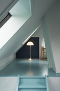 Louis Poulsen Panthella 400 Floor Lamp, white opal acrylic floor lamp, lit under a sloped attic ceiling at the top of a stair