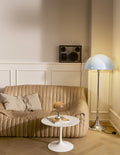 Louis Poulsen Panthella Floor Lamp, Original Opal Blue Grey floor lamp beside a beige sofa, with a Panthella portable lamp on a side table
