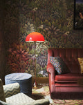 Louis Poulsen Panthella Floor Lamp, Original Opal Red floor lamp, lit beside a velvet armchair against jungle wallpaper