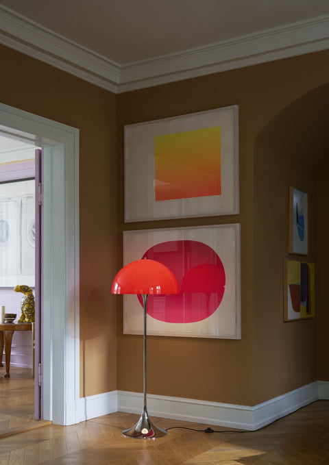 Louis Poulsen Panthella Floor Lamp, Original Opal Red floor lamp, lit in the corner of a brown room below framed prints