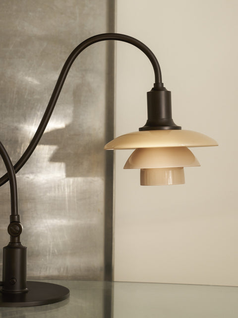 Close-up of the Louis Poulsen PH 1/1 Piano Table Lamp, Limited Edition, showing the dusty terracotta glass shades and aged brass shade holder