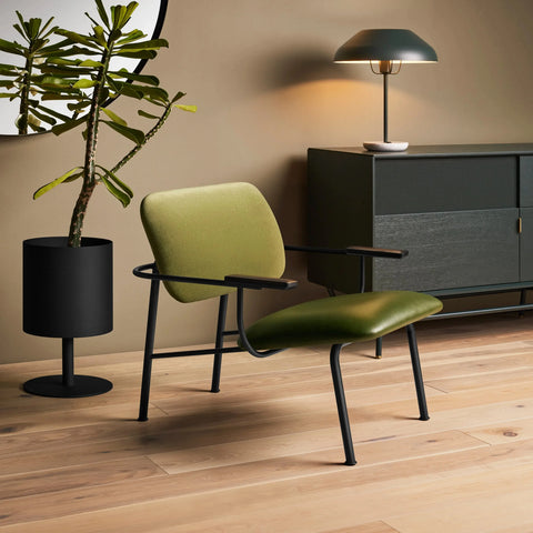 Blu Dot Beau Table Lamp in navy green styled on a sideboard in a moody modern living room