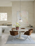 Muuto Midst Table with marble top in contemporary dining room with upholstered armchairs and pendant light