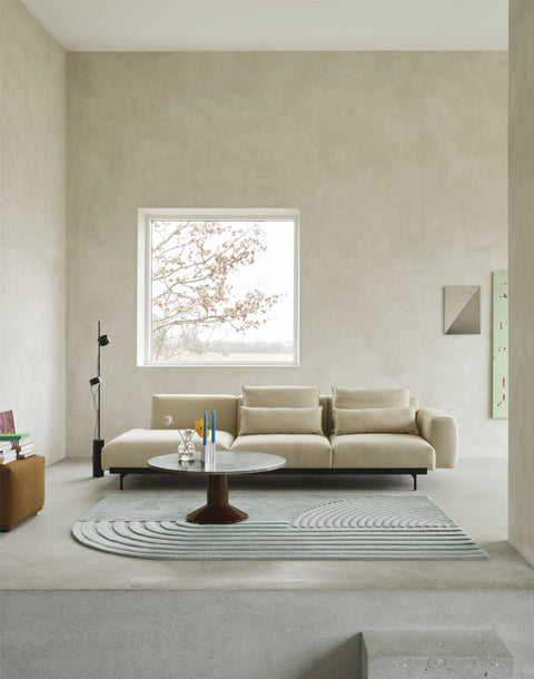 Midst Coffee Table in grey marble with dark red base styled in living room with beige sofa and Relevo rug by Muuto