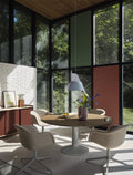 Scandinavian dining room with big windows featuring Muuto fiber soft armchair 