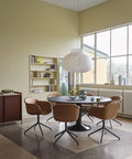 scandinavian dining room with large pendant above table and furniture from muuto 