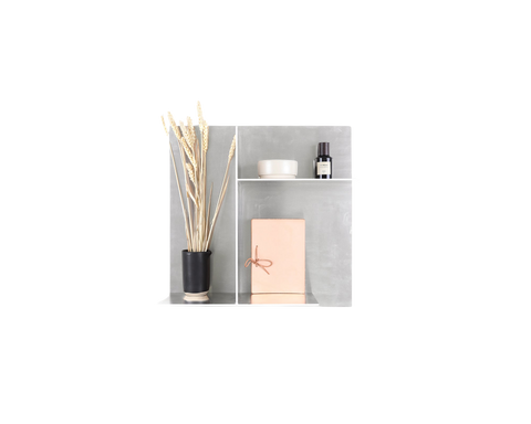 Frama Rivet Typecase in Aluminum, wall box styled with dried reeds, a dark bottle, a small carton and a pink card
